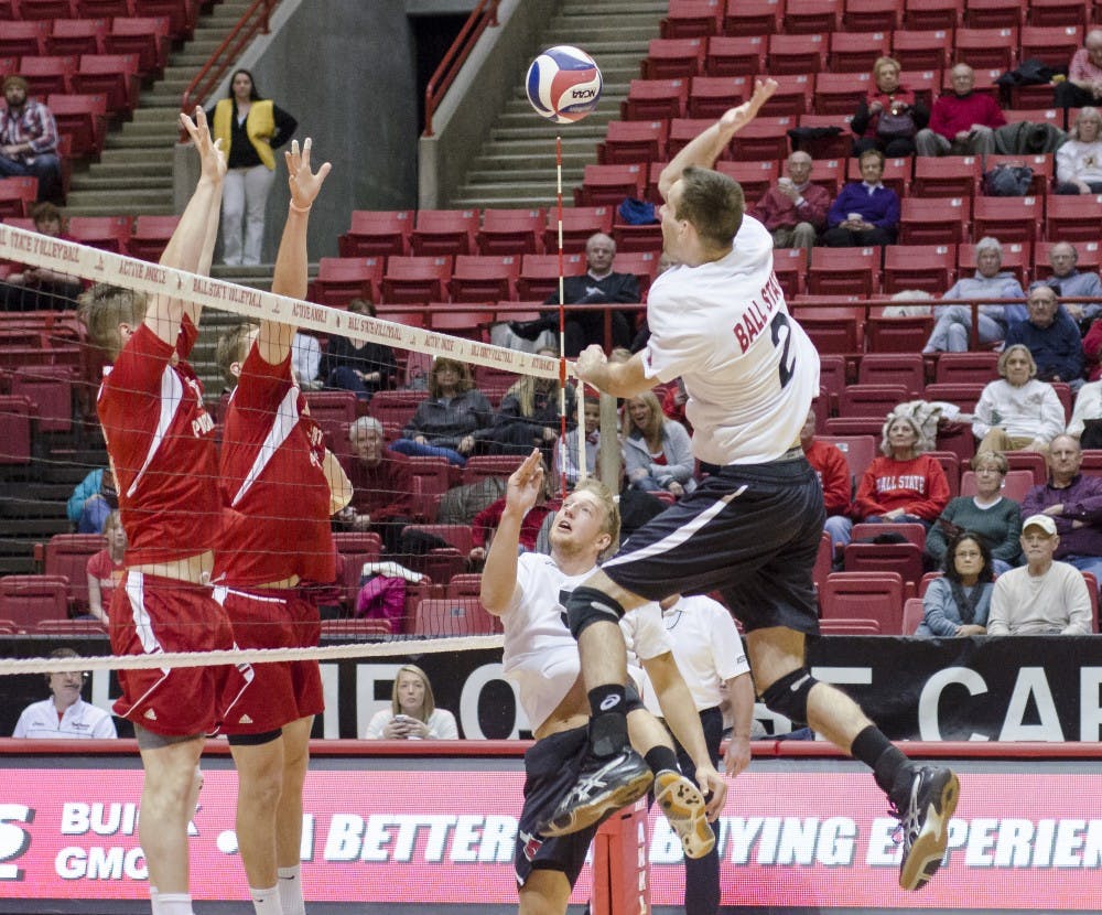 Senior middle attacker Matt Leske drives the ball over the net to score for Ball State. DN PHOTO COREY OHLENKAMP