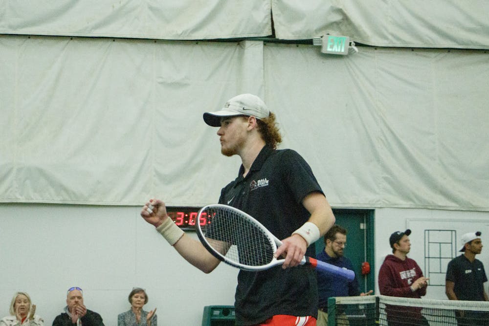 Red-shirt Junior Sajin Smith clenches his fist after winning a point during a singles match against Eastern Kentucky University Feb. 25 at Northwest YMCA. Kate Tilbury, DN