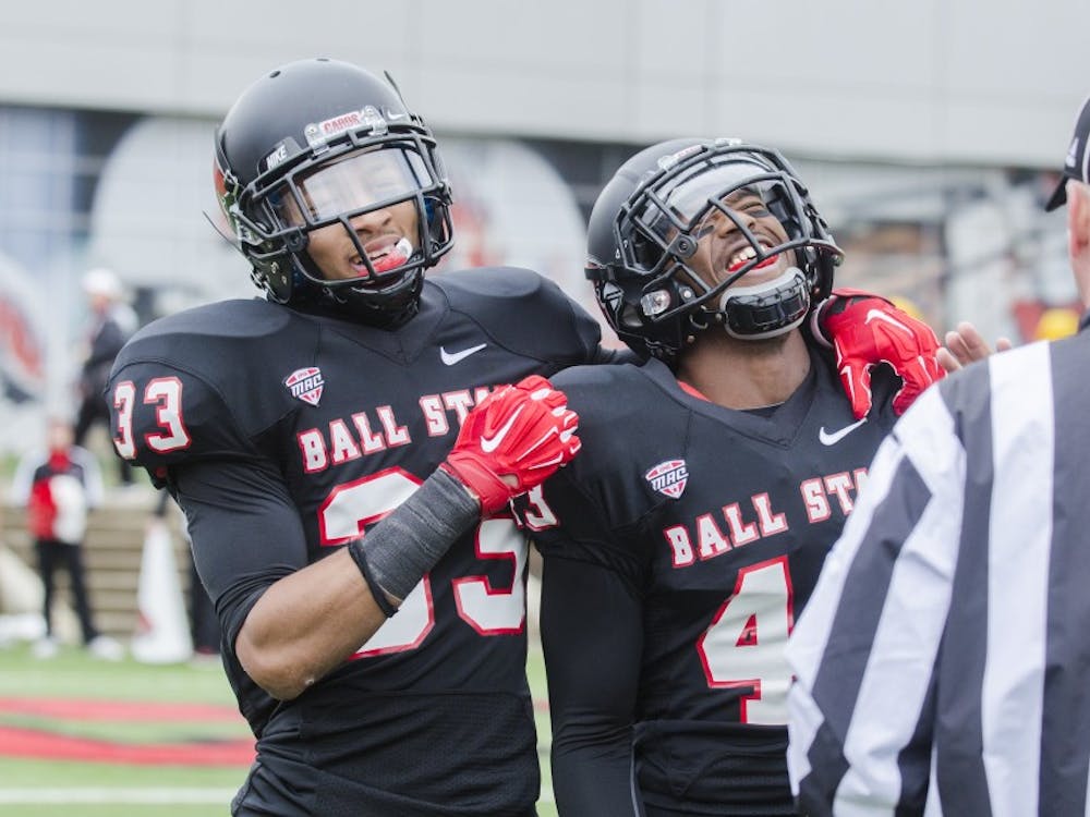Freshman safety Dedrick Cromartie and redshirt sophomore cornerback Tyree Holder react to interception being ruled at an incomplete pass during the game against Eastern Michigan on Nov. 22 at Scheumann Stadium. DN PHOTO BREANNA DAUGHERTY