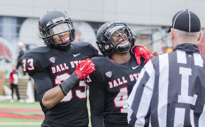 Freshman safety Dedrick Cromartie and redshirt sophomore cornerback Tyree Holder react to interception being ruled at an incomplete pass during the game against Eastern Michigan on Nov. 22 at Scheumann Stadium. DN PHOTO BREANNA DAUGHERTY