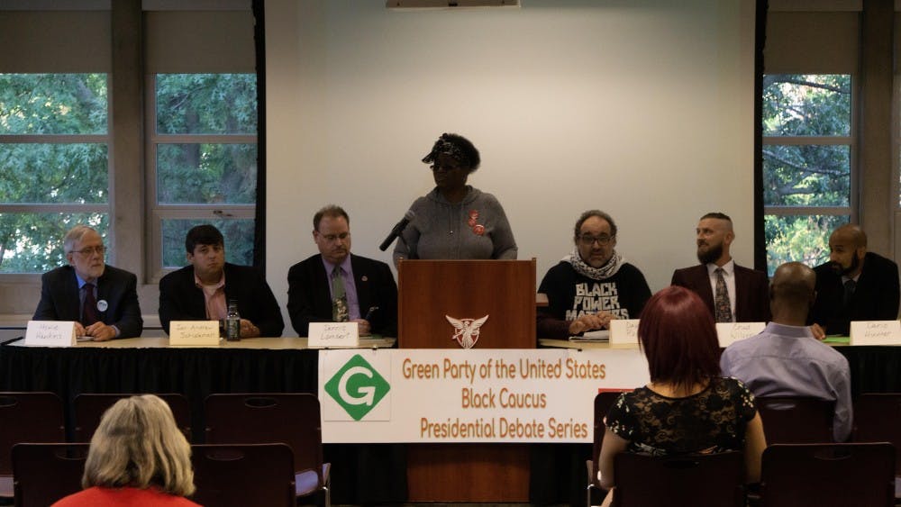 <p>Green Party candidates (left to right) Howie Hawkins, Ian Schlakman, Dennis Lambert, David Rolde, Chad Wilson and Dario Hunter take the stage for the debate as Muncie City Council candidate Monica James (center) speaks at L.A. Pittenger Student Center on Sept. 20. The Green Party’s Black Caucus hosted the event, and candidates were asked questions about social justice, the economy and environment. <strong>John Lynch, DN.</strong></p>