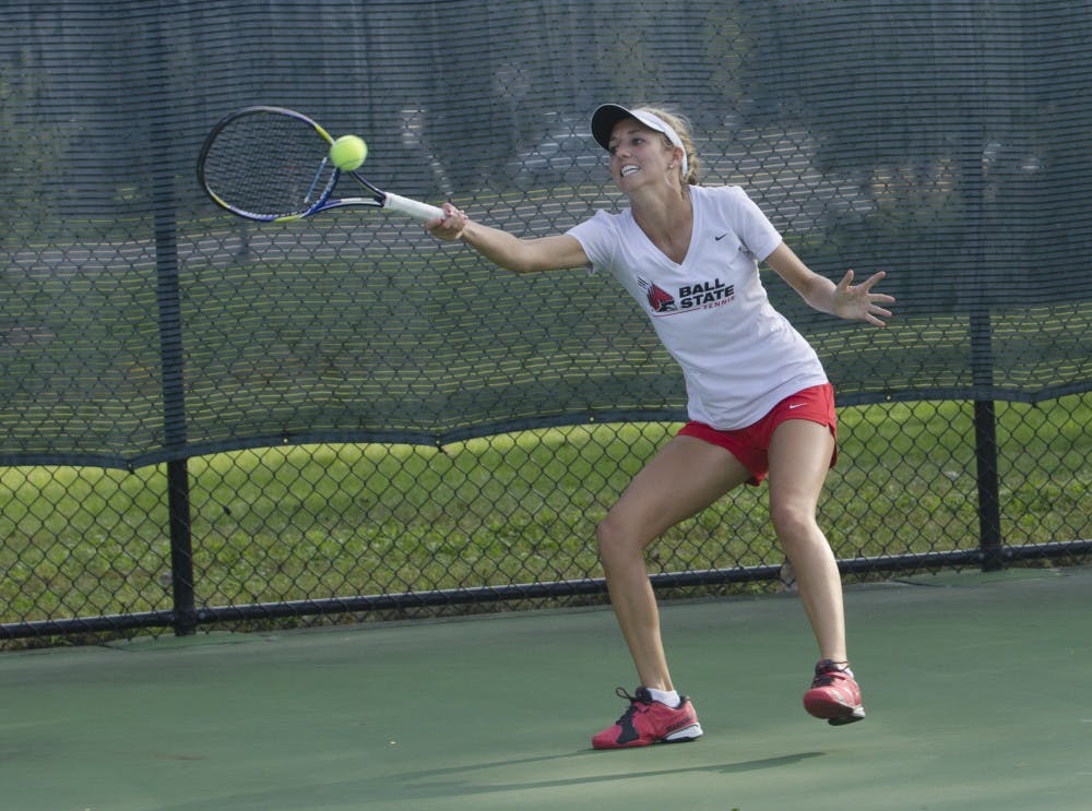 Junior Courtney Earnest reaches for the ball during her singles match against Butler for the Fall Dual on Sept. 20 at the Cardinal Creek Tennis Center. DN PHOTO BREANNA DAUGHERTY 
