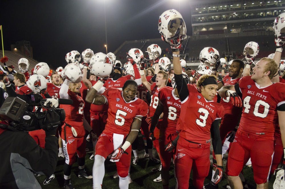 The football team celebrates after a victory during last years