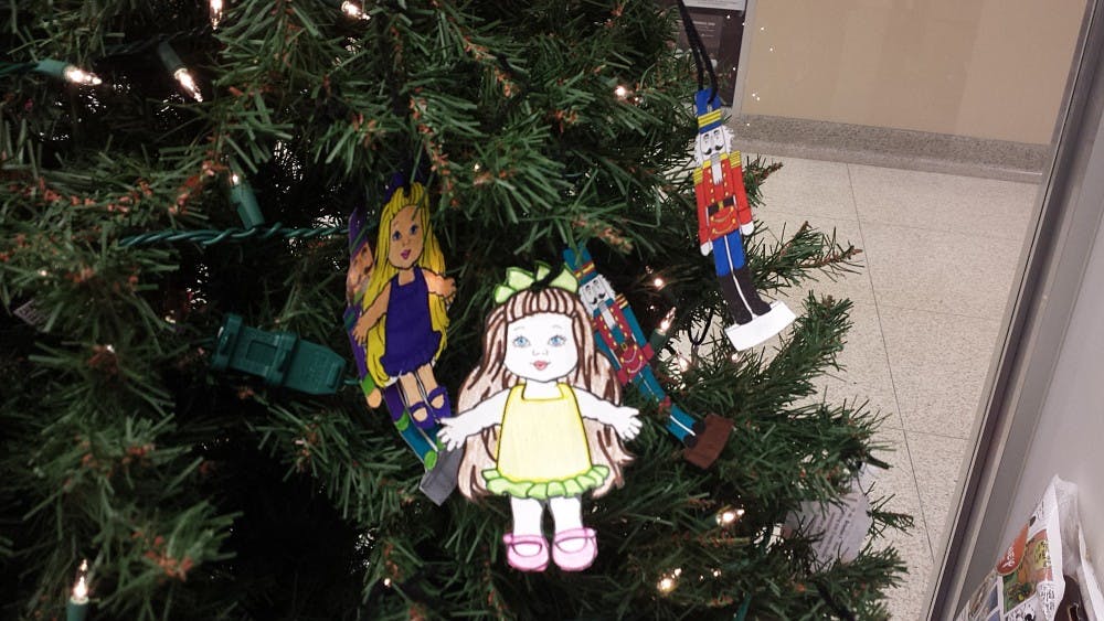 Students can choose an angel off the tree to pick a child. Student Voluntary Services hosts the event in the L.A. Pittenger Student Center. This year, the project is giving presents to 87 children — half of these children received donations in previous years. Gifts can be donated until Dec. 2. DN PHOTO JACOB BURBRINK