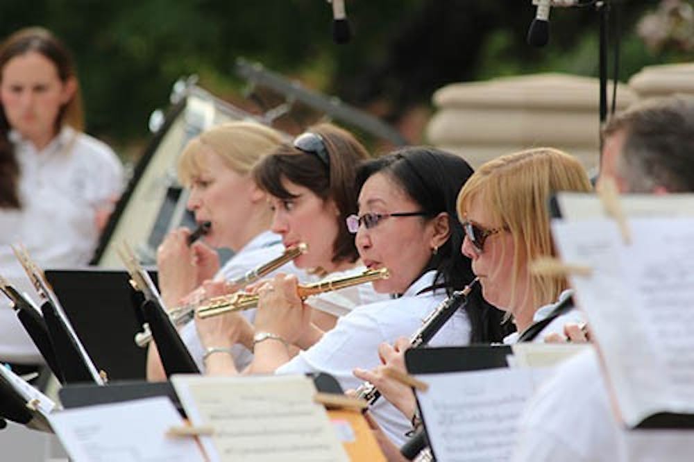 The Muncie Symphony Orchestra flute section plays during the Festival on the Green Saturday.  The Orchestra hosted two contests, an "Around the World" theme picnic and a Super Conductor Contest. DN KRYSTAL BYERS 