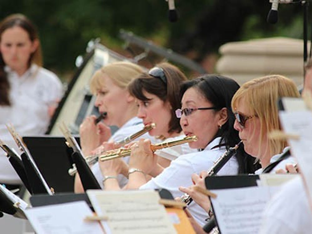 The Muncie Symphony Orchestra flute section plays during the Festival on the Green Saturday.  The Orchestra hosted two contests, an "Around the World" theme picnic and a Super Conductor Contest. DN KRYSTAL BYERS 