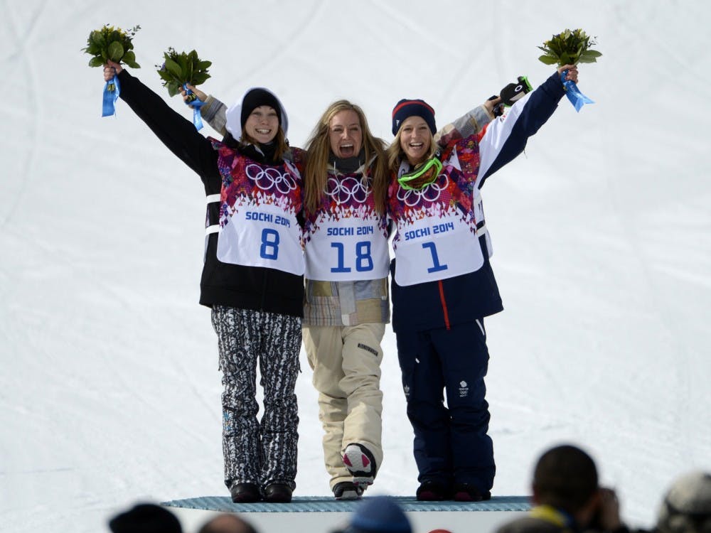 Jamie Anderson, center, of South Lake Tahoe, Calif., celebrates her gold medal win with silver winner Finland