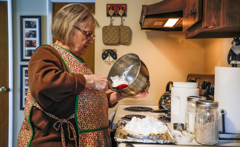 Susan Danner scoops her homemade cream onto her pie Jan. 17 at her home in Muncie. Andrew Berger, DN 
