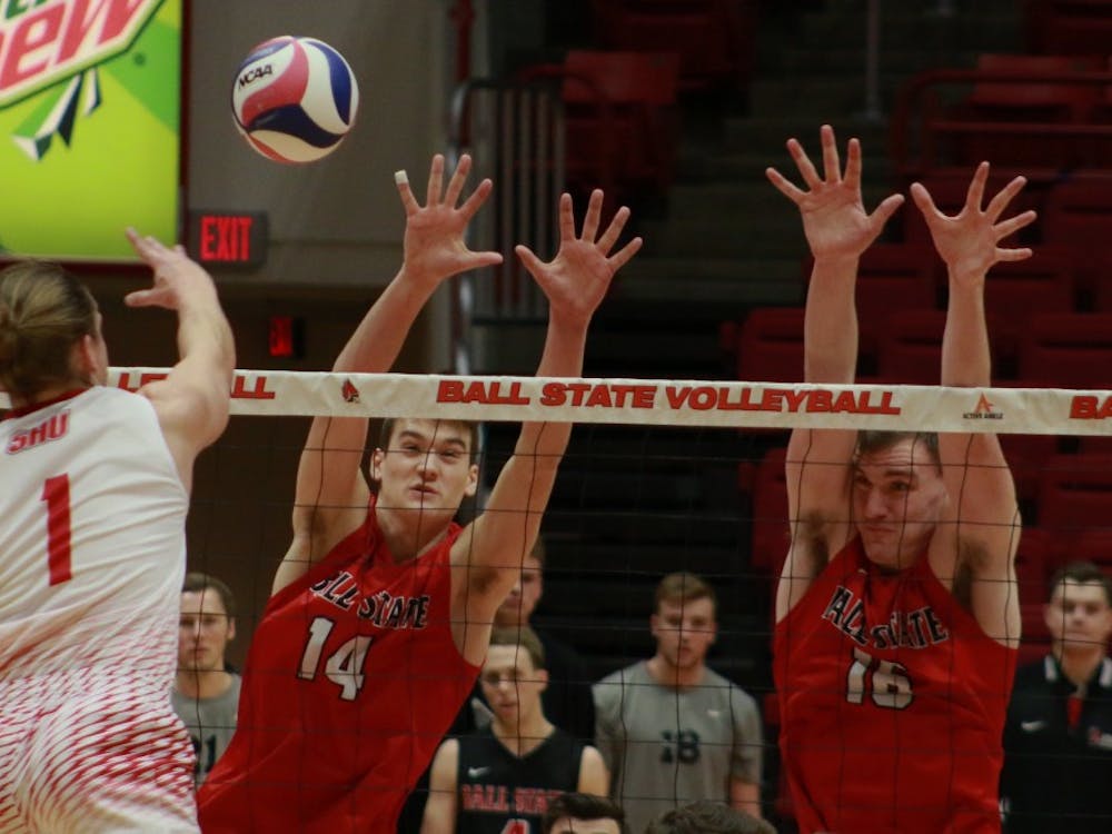Ball State sophomore Matt Szews and senior Matt Walsh just to block a spiked ball from Sacred Heart during the game against on Jan. 19. The Cardinals won 3-2. Carlee Ellison, DN