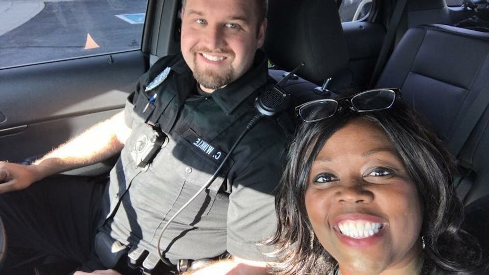 <p>Muncie Police Department officer Chase Winkle selfies with Jeannine Lee Lake, editor and publisher of The Good News, during his first community ride along. <em>Photo Courtesy</em>&nbsp;</p>