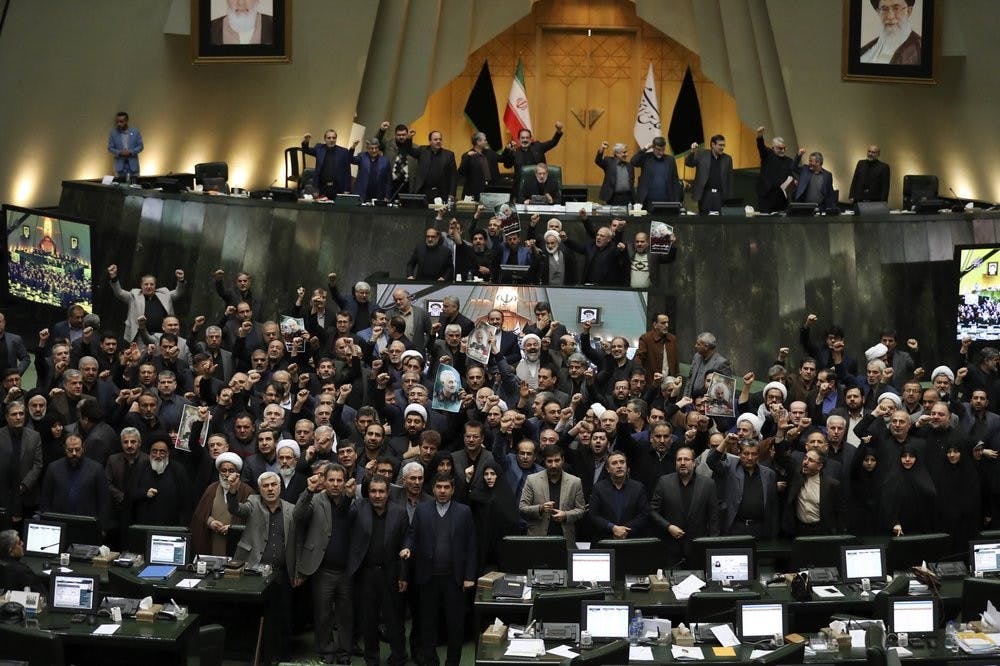 <p>Iranian lawmakers chant slogans as some of them hold posters of Gen. Qassem Soleimani, who was killed in Iraq in a U.S. drone attack, in an open session of parliament, in Tehran, Iran, Tuesday, Jan. 7, 2020. Iran's parliament has passed an urgent bill declaring the U.S. military's command at the Pentagon in Washington and those acting on its behalf "terrorists," subject to Iranian sanctions. <strong>(AP Photo/Vahid Salemi)</strong></p>