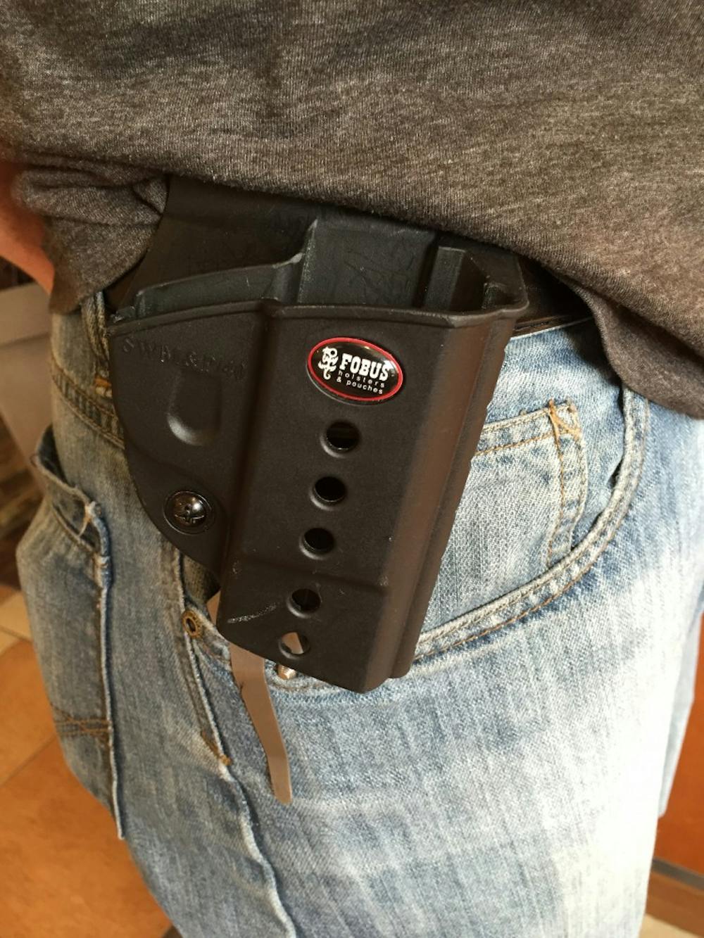 <p>Shown above is an example of an empty holster, demonstrated byDavid Vest, president of Students for Concealed Carry Ball State chapter .<em>DN PHOTO RACHEL PODNER</em></p>