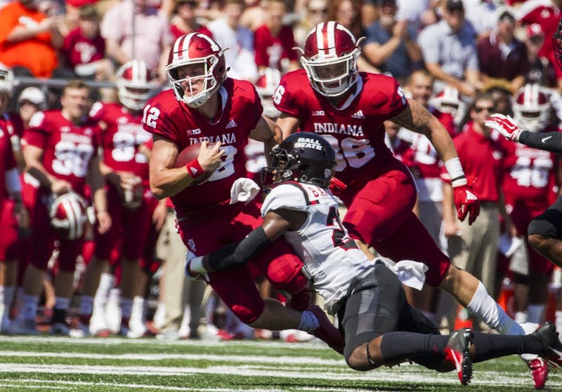 Junior quarter back Peyton Ramsey rushed for a first down and tackled sophomore safety Brett Anderson II Saturday, September 15, at Memorial Stadium, in Bloomington, IN. Ramsey passed 173 yards for IU, helping defeat Ball State, 10-38. Grace Hollars, DN