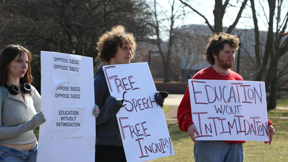 Protesters hold signs related to opposition of Indiana Senate Bill (SB) 202 Feb. 22 on University Green. The protest, hosted by the Young Democratic Socialists of America, opposed SB 202. Olivia Ground, DN