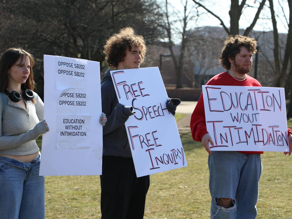 Protesters hold signs related to opposition of Indiana Senate Bill (SB) 202 Feb. 22 on University Green. The protest, hosted by the Young Democratic Socialists of America, opposed SB 202. Olivia Ground, DN