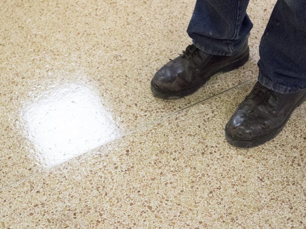 Custodian Greg Hobson stands in the entry way of one of the halls at the LaFollette Complex. Earlier in the break Hobson had stripped and re-waxed the floors, a task which he takes pride in. DN PHOTO JORDAN HUFFER