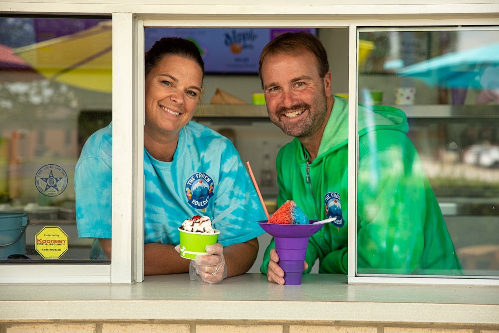 Kyla and Dave Bartle pose with frozen treats from their ice cream shop, The Frozen Boulder, Aug. 26, 2020. They thought of the name for their shop from the mini-golf course they own across the parking lot named, Boulder Falls. Jacob Musselman, DN Illustration