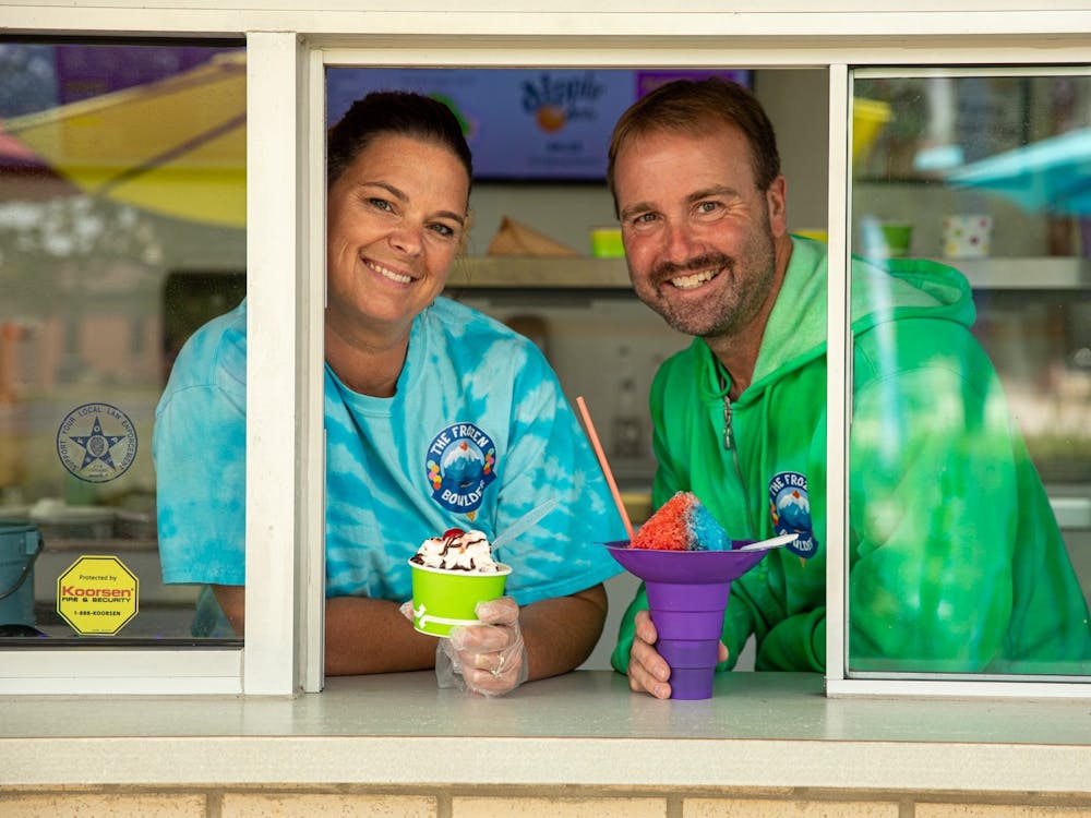 Kyla and Dave Bartle pose with frozen treats from their ice cream shop, The Frozen Boulder, Aug. 26, 2020. They thought of the name for their shop from the mini-golf course they own across the parking lot named, Boulder Falls. Jacob Musselman, DN Illustration