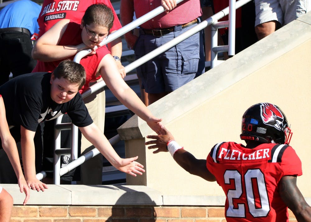 Ball State fans high five graduate student running back Walter Fletcher after the Cardinals' game against Florida Atlantic Saturday, Sept. 14, 2019, at Scheumann Stadium. Ball State lost, 31-41. Paige Grider, DN