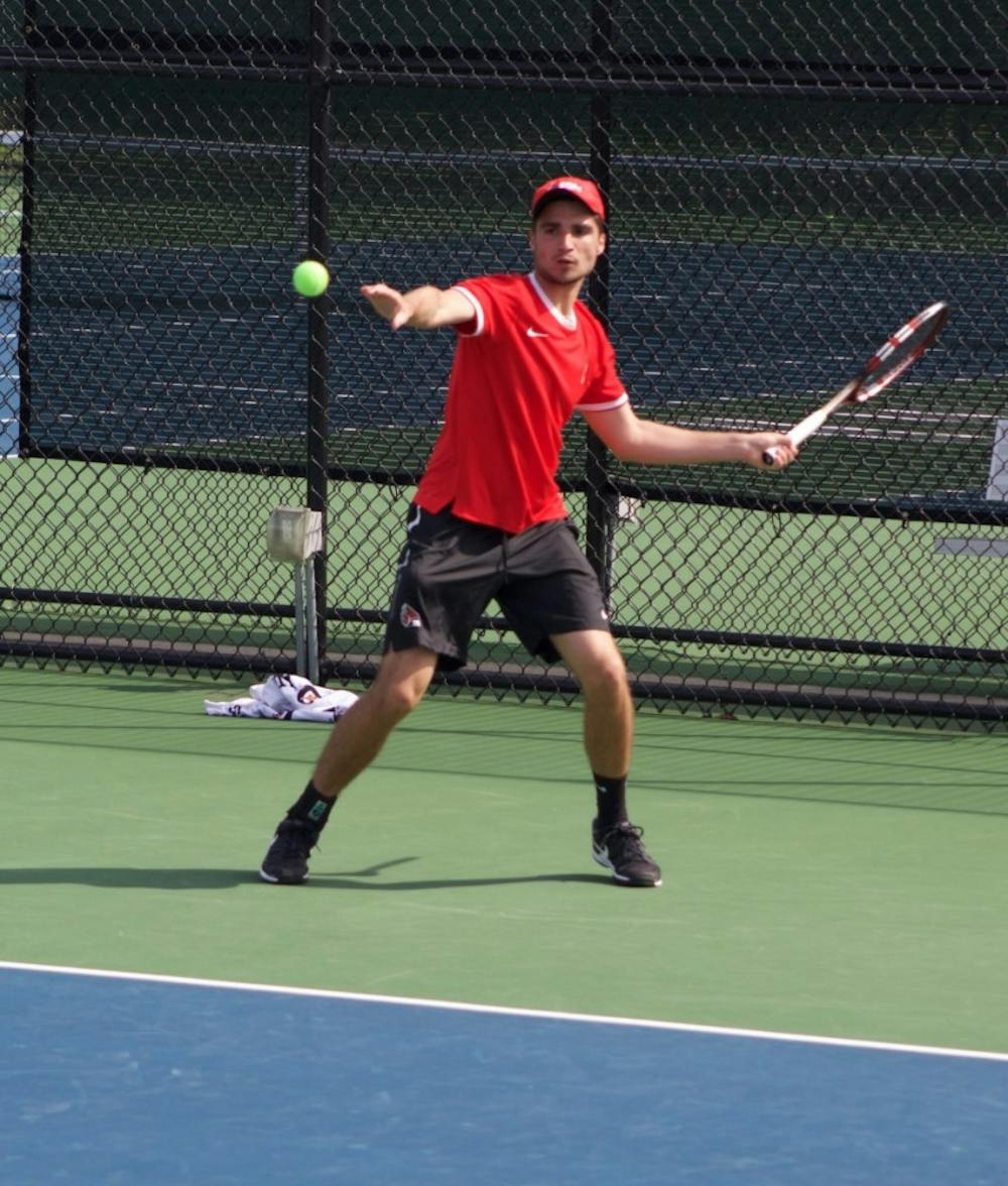 Junior Marko Guzina attempts to hit a ball back against IUPUI on April 12 at Cardinal Creek Tennis Center. Guzina lead late in the second set by 4-3. Patrick Murphy, DN File