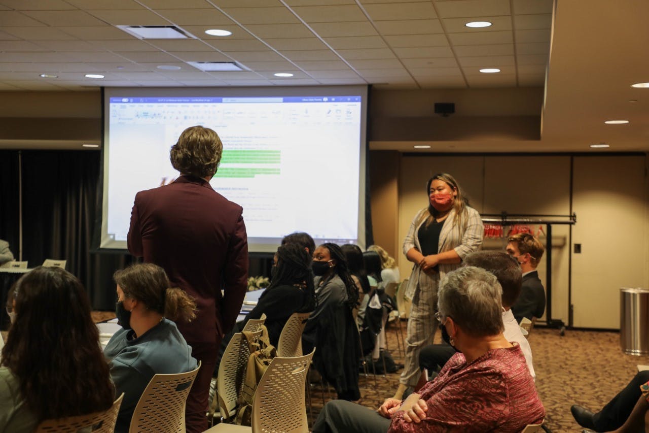 Student Government Association (SGA) senator Grant Wilson speaks to SGA President Tina Nguyen during SGA&#x27;s Nov. 10 meeting held in the L.A. Pittenger Student Center. Wilson co-authored an amendment that proposes to establish a student voter minimum for SGA executive elections. Hannah Amos, DN