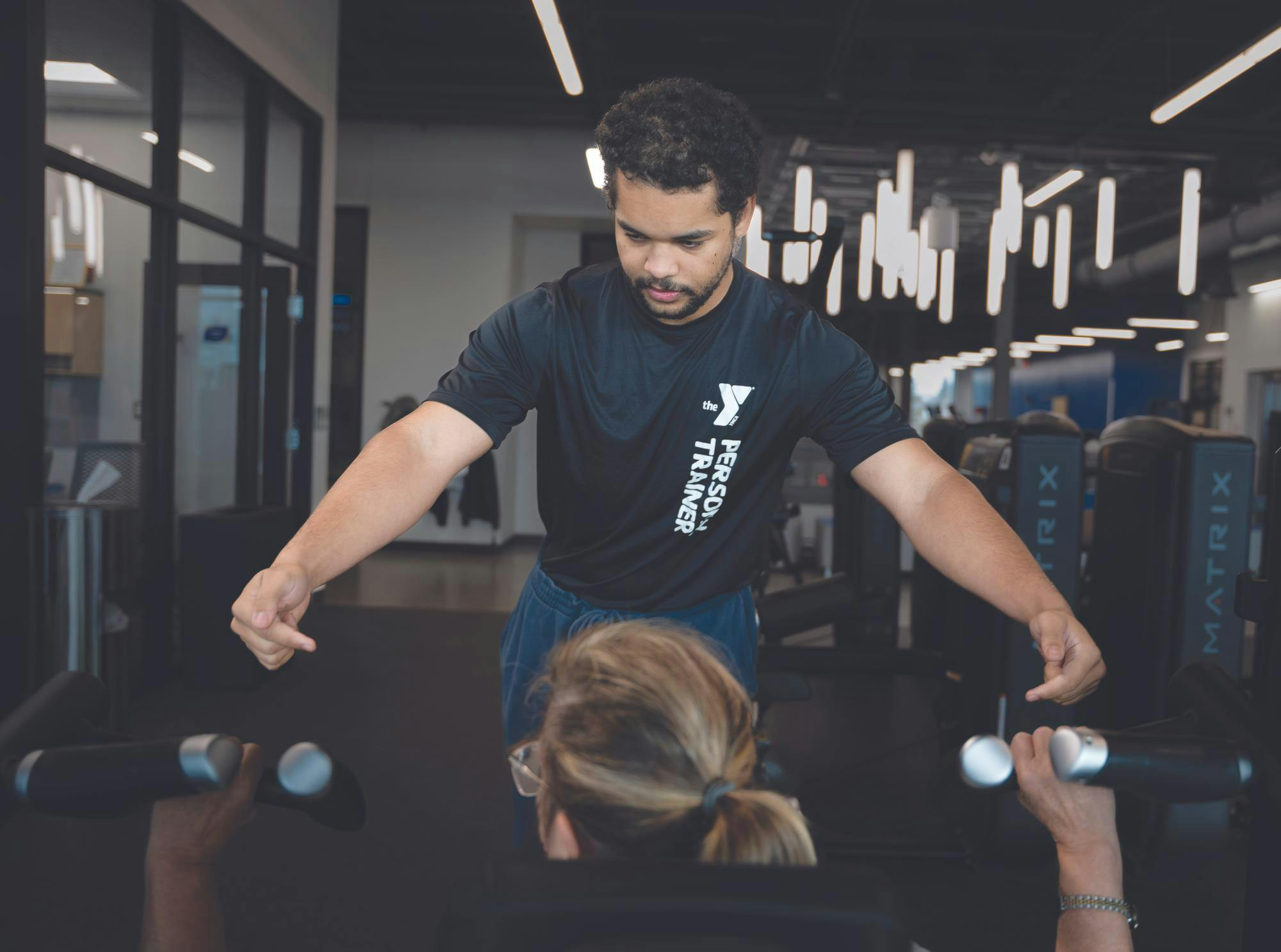YMCA Trainer Tre Phillips assists client Suzanna Lopiccolo with her workout Jan. 8 at the YMCA of Muncie. Kyle Ingermann, DN