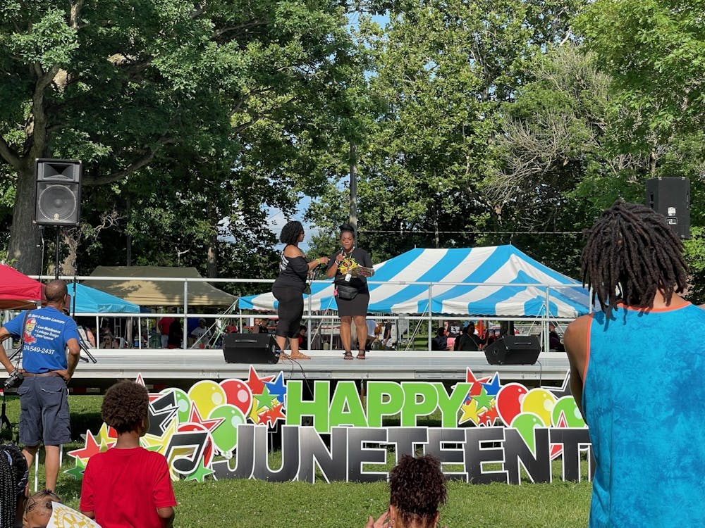 Juneteenth Committee cochairs Anitra Davis and Dorica Watson take the stage to announce awards to notable members of the Muncie community in McCulloch Park July 17, 2021. Davis is the city council representative for District 6 in Muncie. Iris Tello, DN