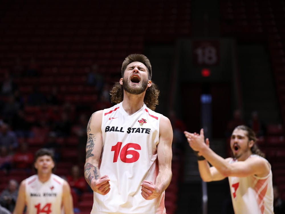 Graduate Student middle blocker Wil McPhillips celebrates scoring a point against Quincy April 4 at Worthen Arena. McPhillips scored four points in the game. Mya Cataline, DN