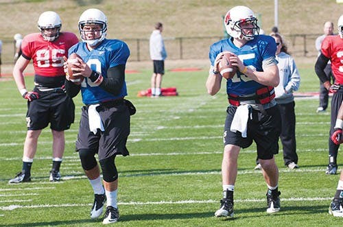 Ball State quarterbacks Keith Wenning, left, and Ozzie Mann prepare to pass during practice on Friday. Mann attended Delta High School in Muncie. DN PHOTO BOBBY ELLIS