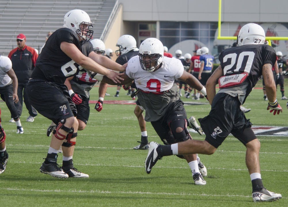 Junior defensive end Michael Ayers runs a play during practice on Aug. 21 at Scheumann Stadium. Ayers made his first career start on Sept. 7, 2013,  against Army at Scheumann Stadium. DN PHOTO BREANNA DAUGHERTY