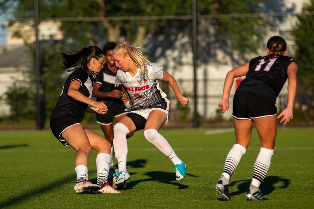 Midfielder/forward Amanda Shaw attempts to fight past three players from the University of Nebraska-Omaha in the final drive before time expired Friday, Sept. 14, 2018 at Briner Sports Complex. The Cardinals defeated Omaha 3 to 1 with all goals being scored in the second half of the game. Eric Pritchett,DN