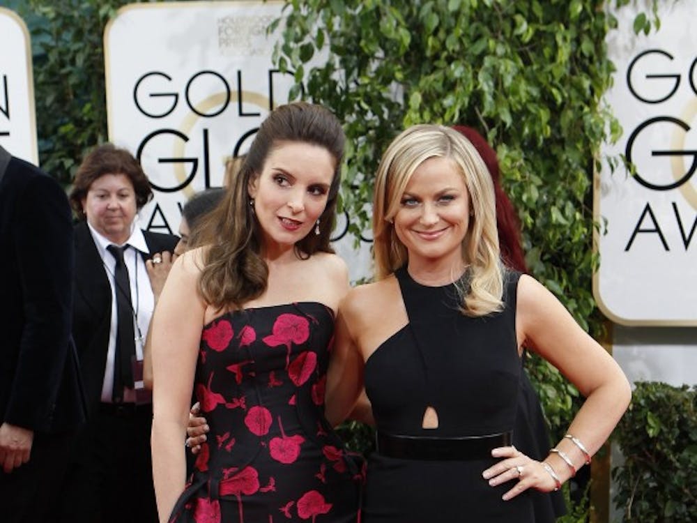 Tina Fey and Amy Poehler, right, arrive for the 71st Annual Golden Globe Awards show at the Beverly Hilton Hotel on Sunday, Jan. 12, 2014, in Beverly Hills, Calif. (Wally Skalij/Los Angeles Times/MCT)