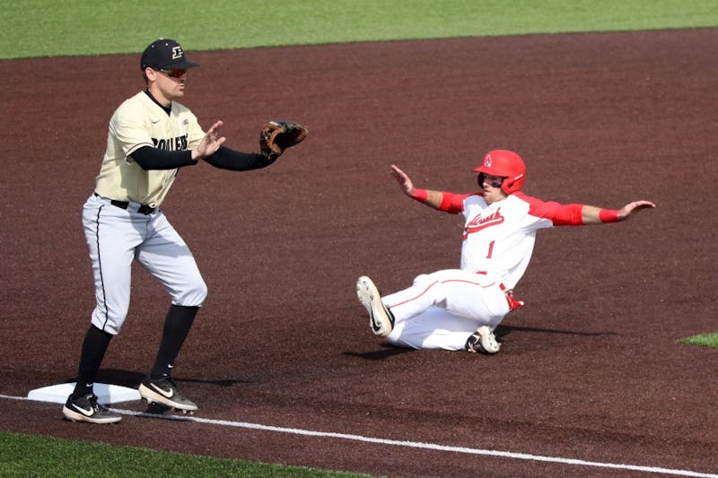 Purdue senior third baseman Nick Evarts calls off junior catcher Bryce Bonner as junior center fielder Aaron Simpson steals third during the Boilermakers' game against Ball State March 19, 2019 at Ball Diamond at First Merchants Ballpark Complex in Muncie, IN. Ball State's 6 to 0 win over Purdue gives them a 11-9 record. Paige Grider, DN