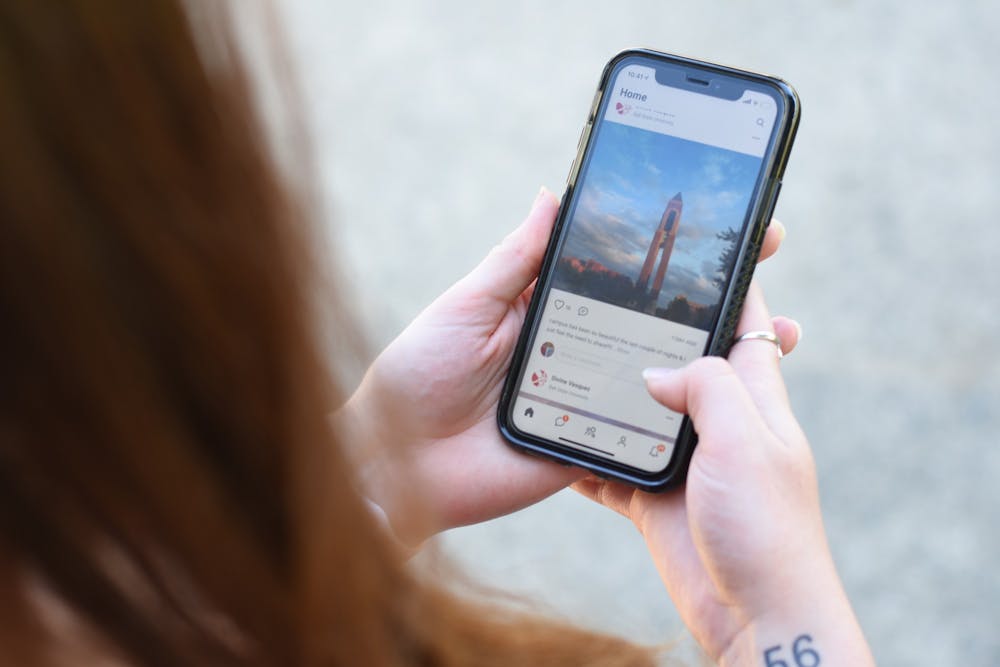 <p>A girl views the ZeeMee app on her mobile phone. Ball State is using the ZeeMee app for virtual student orientation to help students connect with each other before they arrive on campus. <strong>Tyler Griffith, DN Illustration</strong></p>