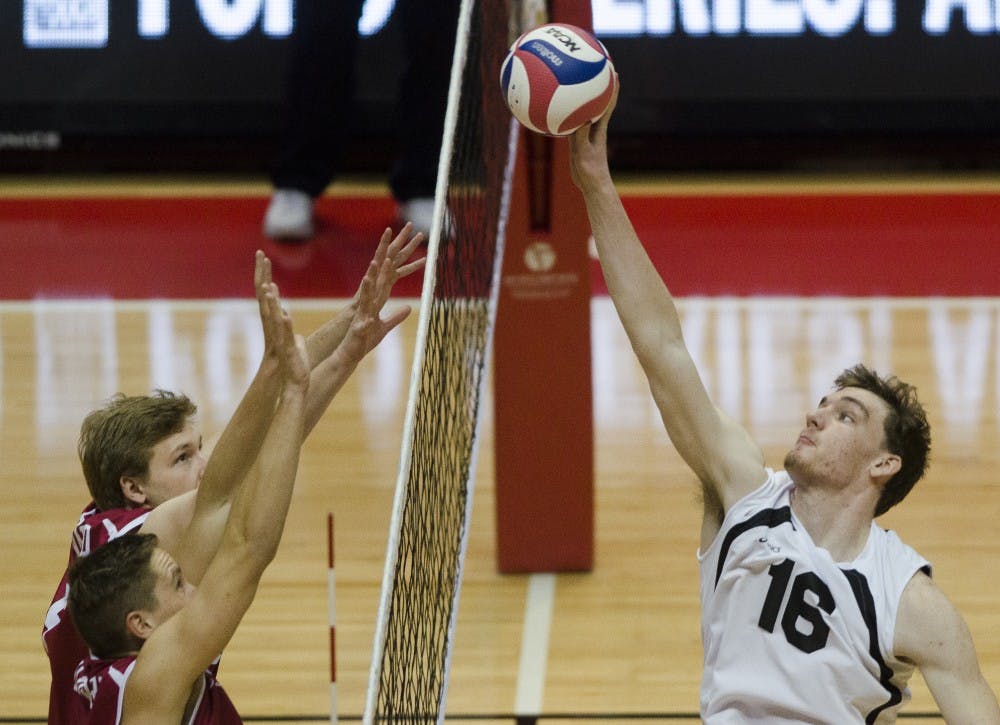 Sophomore middle attacker Matt Walsh attempts to get the ball over the net during the match against Harvard on Jan. 15 at Worthen Arena. DN PHOTO BREANNA DAUGHERTY