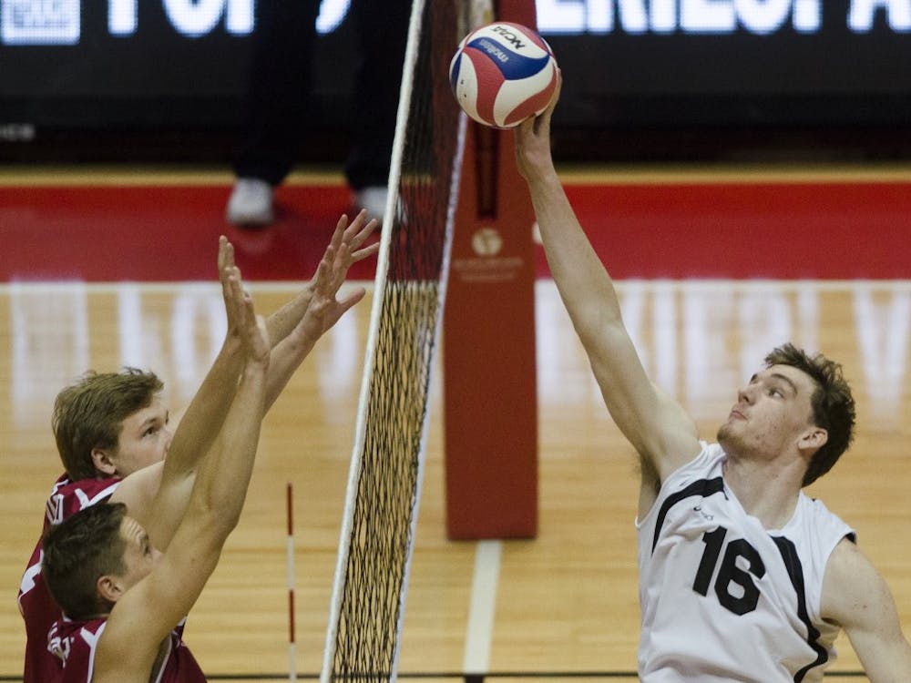 Sophomore middle attacker Matt Walsh attempts to get the ball over the net during the match against Harvard on Jan. 15 at Worthen Arena. DN PHOTO BREANNA DAUGHERTY