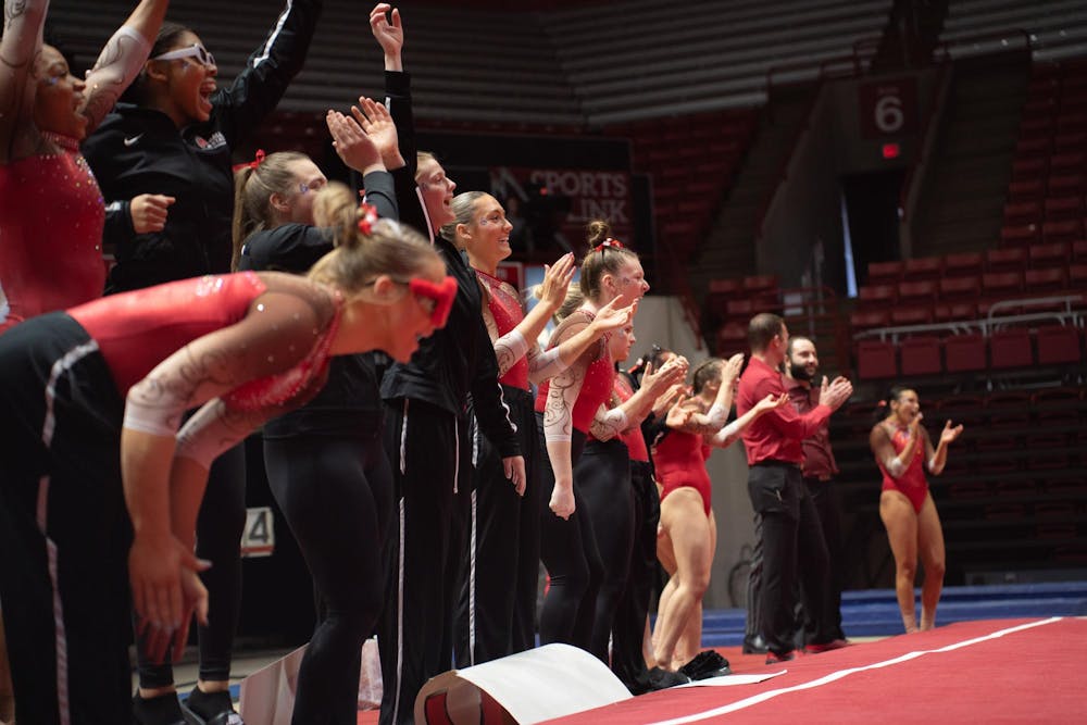 Ball State Women's Gymnastics cheers during the Cardinal's floor routine event against Kent State Feb. 4 at Worthen Arena. The Cardinals won 196.075 vs 195.525.  Kate Tilbury, DN
