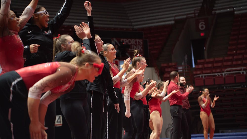Ball State Women's Gymnastics cheers during the Cardinal's floor routine event against Kent State Feb. 4 at Worthen Arena. The Cardinals won 196.075 vs 195.525.  Kate Tilbury, DN