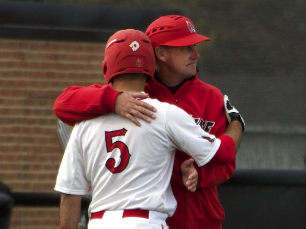 Ball State’s head baseball coach Rich Maloney gives senior infielder Ryan Spaulding a hug while the players from Ohio take a time out in the game on April 1. DN PHOTO GRACE RAMEY