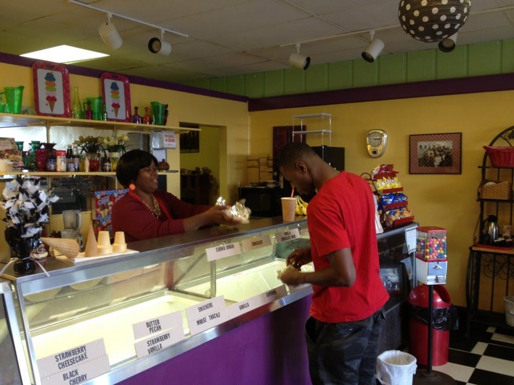 Jeannine Lake, owner of Grandma Bettyâ€™s Ice Cream Shop, serves a customer a Snickers milkshake and a pulled pork sandwich, a new item to the menu of the restaurant.