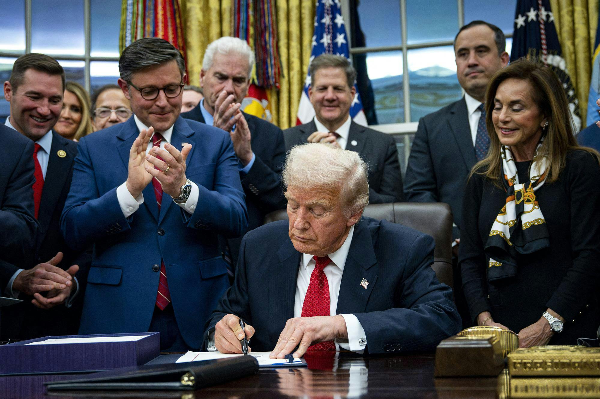 U.S. President Donald Trump signs the funding package to re-open the federal government in the Oval Office of the White House in Washington, D.C., on Wednesday, Nov. 12, 2025. The short-term spending bill funds the government through Jan. 30 and ended the longest shutdown in U.S. history. (Bonnie Cash/Pool/CNP/DPA/Abaca Press/TNS)