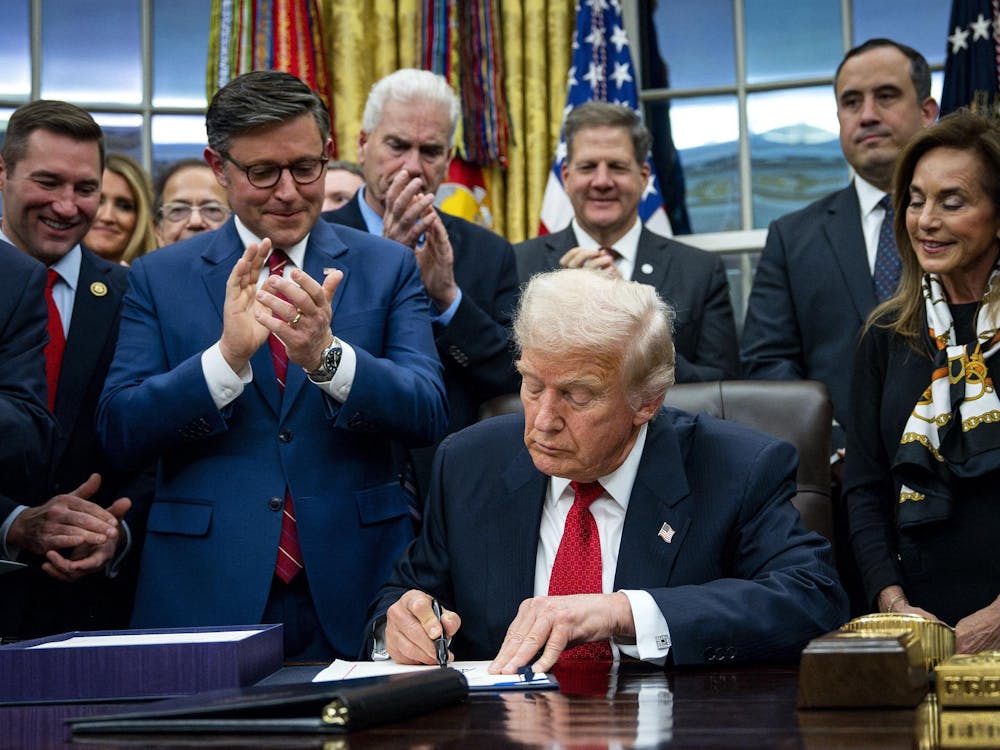 U.S. President Donald Trump signs the funding package to re-open the federal government in the Oval Office of the White House in Washington, D.C., on Wednesday, Nov. 12, 2025. The short-term spending bill funds the government through Jan. 30 and ended the longest shutdown in U.S. history. (Bonnie Cash/Pool/CNP/DPA/Abaca Press/TNS)