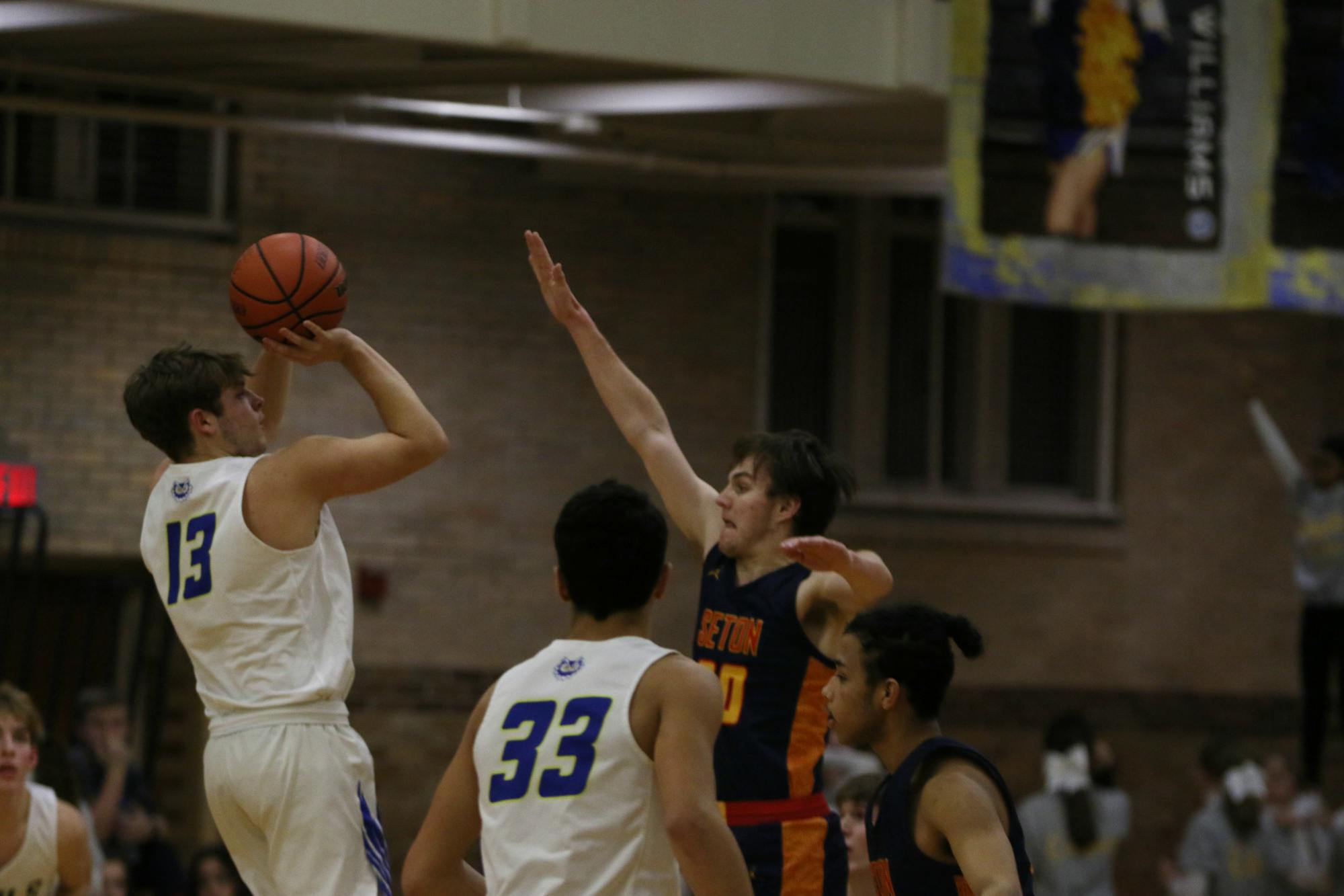 Senior Connor McKibben attempts a shot over a Seton Catholic Defender Jan. 27 at Ball Gymnasium. Zach Carter, DN