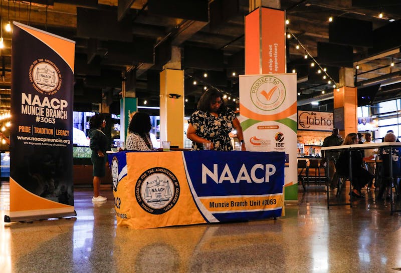 A welcoming booth set up by the NAACP Sept. 26 at The Clubhouse in Downtown Muncie. A few different community organizations put on the drive in hopes of building the value of voting in the younger generation. Andrew Berger, DN 
