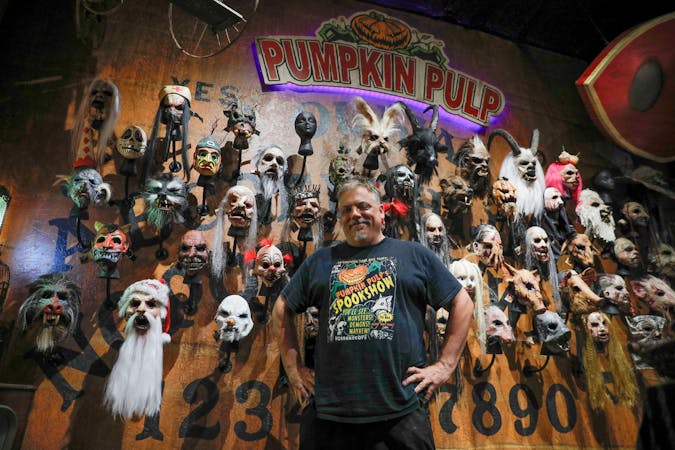 Brian Blair stands in front of a wall of masks in the shop Sept. 27 at Pumpkin Pulp. Brian Blair began the business in 2006. Andrew Berger, DN