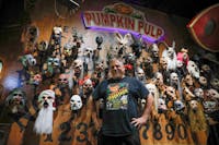 Brian Blair stands in front of a wall of masks in the shop Sept. 27 at Pumpkin Pulp. Brian Blair began the business in 2006. Andrew Berger, DN