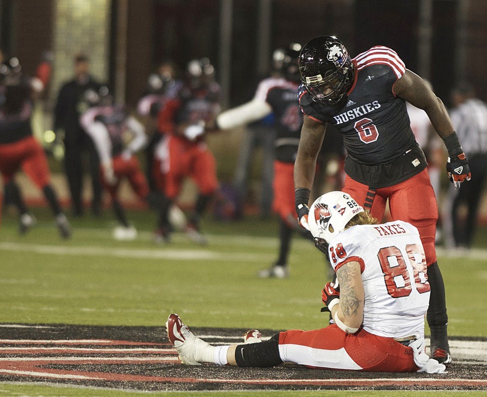 Northern Illinois linebacker Lamaal Bass lends Ball State tight end Zane Fakes a hand after his catch was intercepted late in the fourth quarter on Nov. 13 at Huskie Stadium. DN PHOTO MARCEY BURTON