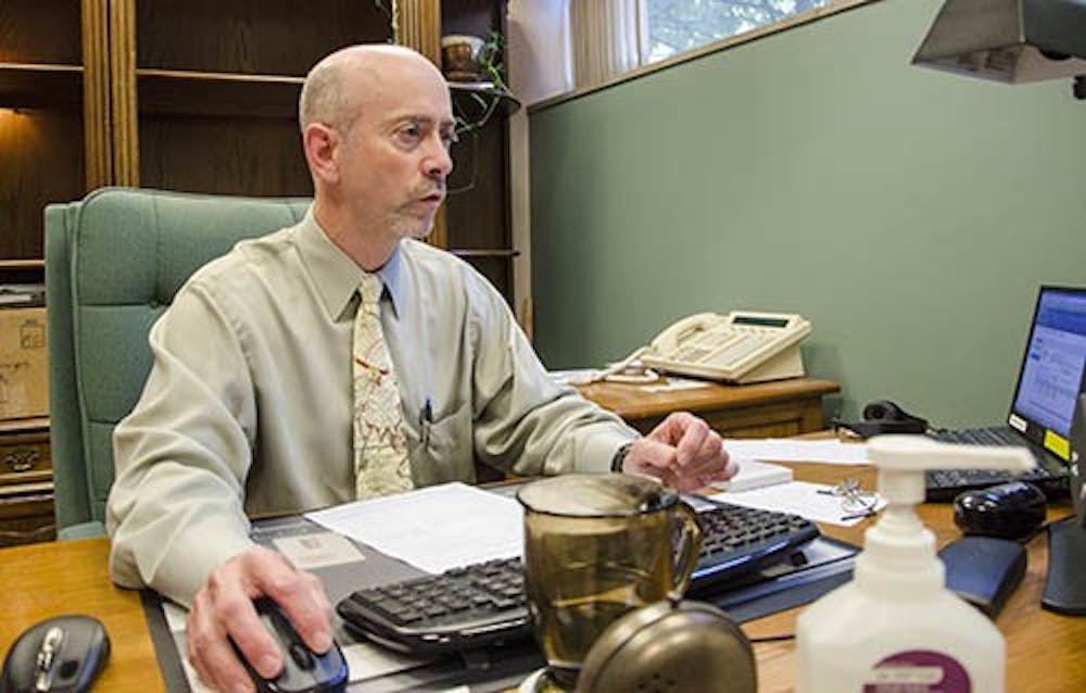 Former Ball State Medical Director Kent Bullis sits in his office at the Amelia T. Wood Health Center.