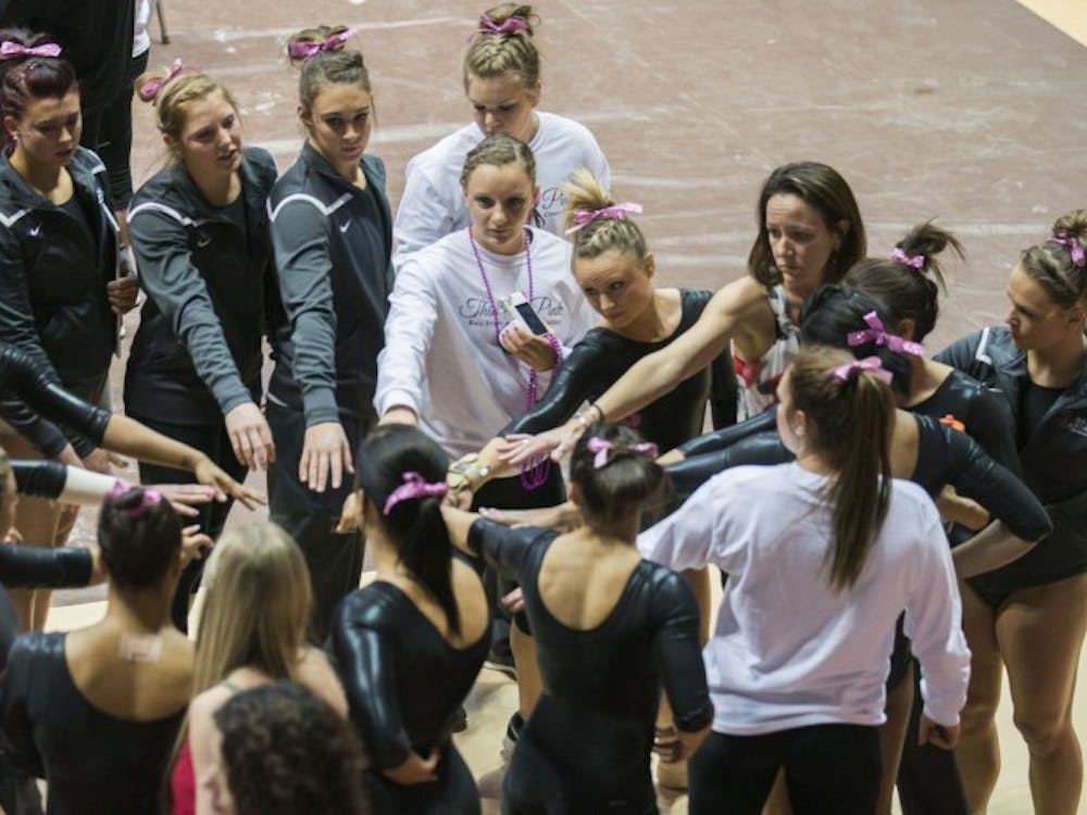 The Ball State gymnastics team coming together during its quad meet on Feb. 14 at Worthen Arena.