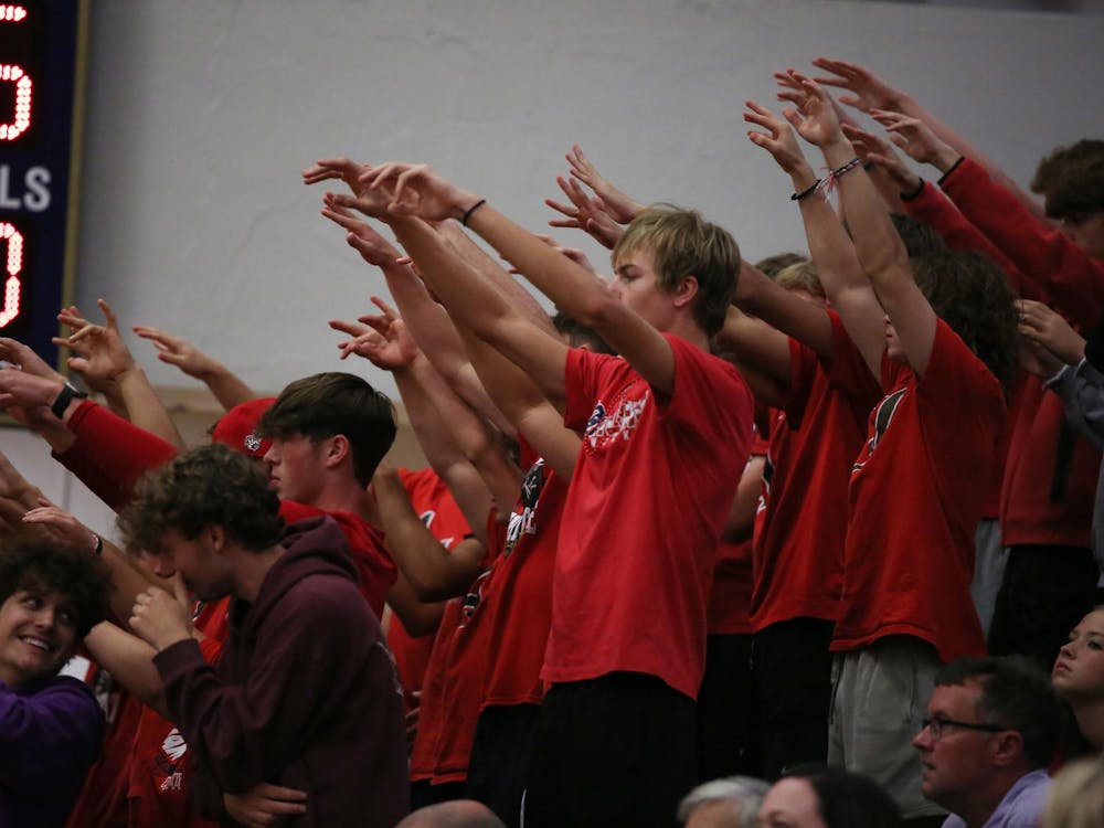 Wapahani's studnet section does spiritfingers Aug. 21 during a volleyball match against Delta at Delta High School. Wapahani won after five sets. Zach Carter, DN.